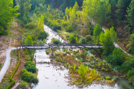  Mountain river in Spain early in the morning. Spanish landscape with stream, water, and bridge. の写真素材