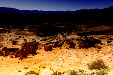 Rocky hills of the Negev Desert in Israel early in the morning. Breathtaking landscape at sunrise, desert rock formations, dusty mountains, wadis  and deep craters. の写真素材