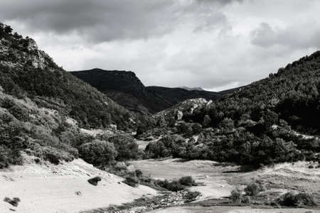 Beautiful landscape in Spain with dramatic view of Cantabrian Mountains. Dry riverbed on the bottom of canyon の写真素材
