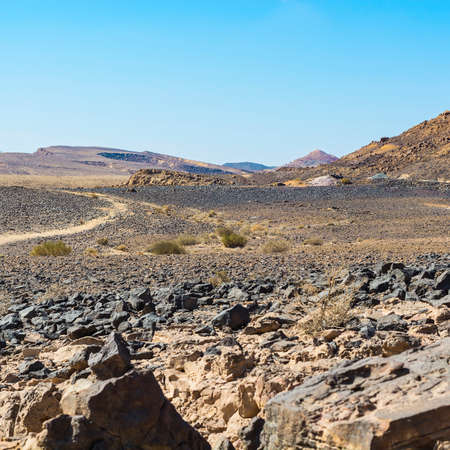 Desolate infinity of the Rocky hills of the Negev Desert in Israel. Breathtaking landscape and nature of the Middle East.の写真素材
