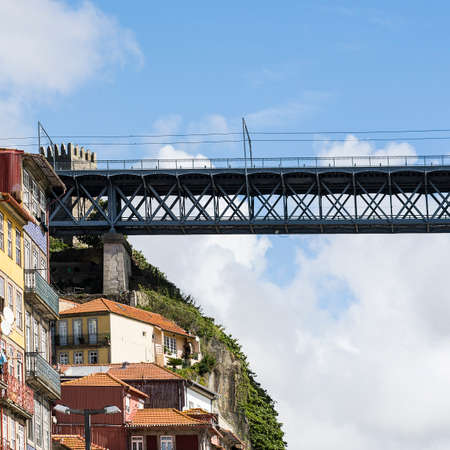 Bridge Built by Eiffel on the Bacground of the historical centre of the city of Porto with traditional Portuguese facades sometimes decorated with ceramic tiles of azulejoのeditorial素材