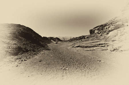 Loneliness and emptiness of the rocky hills of the Negev Desert in Israel. Breathtaking landscape and nature of the Middle East. Black and white photoの写真素材