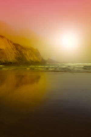 Portuguese Atlantic Ocean beach in the morning mist at sunrise. Breathtaking landscape and nature of the Portugal, popular travel destination in western Europe. の写真素材