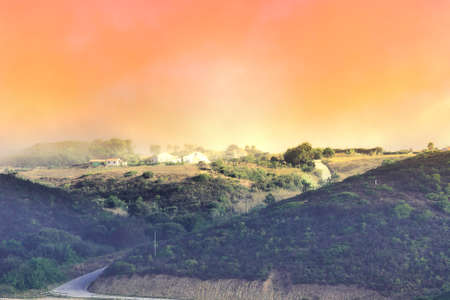 Small Portuguese village  with white houses and red tile roofs. Morning mist under popular travel destination in Portugalの写真素材