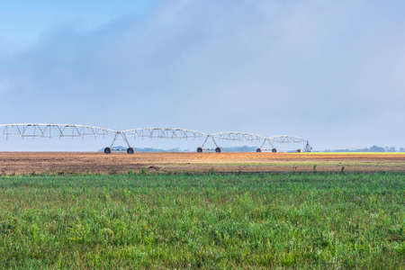 Sprinkler irrigation system watering a field in Portugal. の写真素材