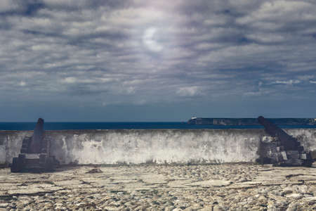 Old rusty cannon guarding the Portuguese fortress Sagres on the Atlantic Ocean beach in the light of the moon. Breathtaking landscape of the Portugal, popular travel destination in western Europe.の写真素材