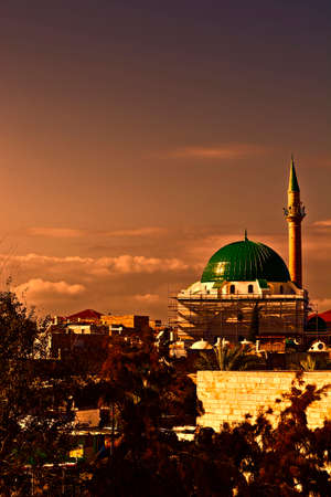 Restoration of Muslim mosque in the old city of Akko at sunset. Al-Jazzar mosque as fine example of the Ottoman architecture in old Acre, Israel.の写真素材