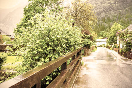 Morning mist over the Austrian village Hallstatt.   Rain and clouds in rural Austria. Vintage styleの写真素材