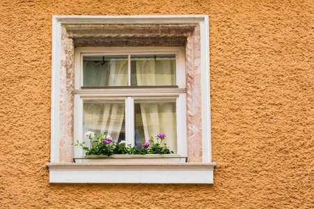 Typical windows of a house in a small town in Austria. Home in the Austrian city of Gmunden in a...