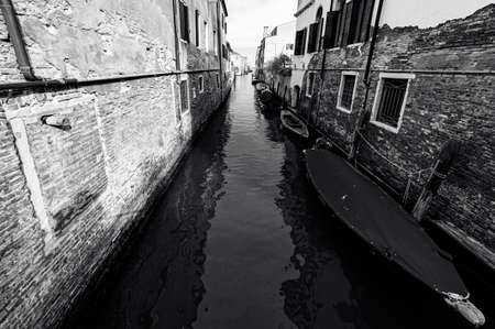 Deserted Venice in black and white.  City is situated across a group of islands that are separated by canals and linked by empty bridges.の写真素材