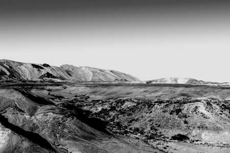 Rocky hills of the Negev Desert in Israel. Breathtaking landscape of the rock formations in the Southern Israel. Dusty mountains interrupted by wadis  and deep craters.の写真素材