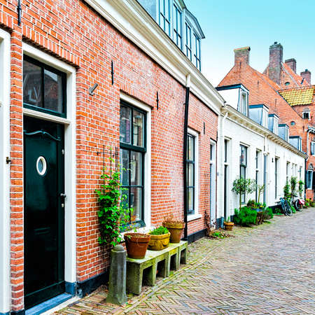 Typical Dutch brick houses in Holland. Street View with bikes parked in the historical center of Amersfoort in the Netherlandsの写真素材