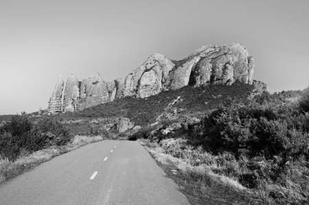 Deserted road in Spain in black and white. Paved narrow path to a canyon in the Spanish Pyrenees.の写真素材