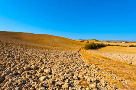 Plowed hills of Tuscany in the autumn. Plowed agricultural land in Italyの写真素材