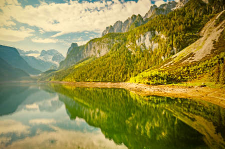 Austrian landscape with forests, meadows, fields and pastures surrounding the lake Gosausee on the...