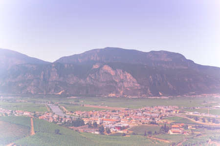 Panorama of the gorgeous Lake Garda surrounded by mountains in Riva del Garda in Italy in faded...