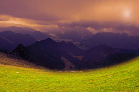 View of the German city in the Alpine valley from the height of the Bavarian Alps in inclement...