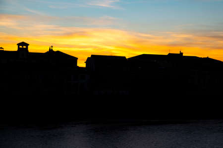Silhouette at sunset - the Italian medieval city of Verona on the river Adigeの写真素材