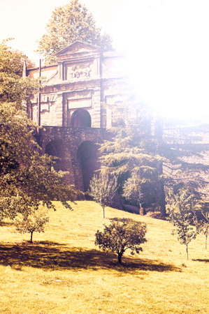 The walls surrounding the old city of Bergamo in Italy are an example of Venetian military architecture at sunsetの写真素材