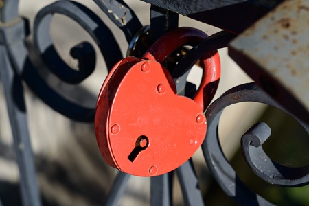 Red heart-shaped lock on the bridge の写真素材