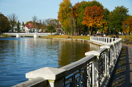 KALININGRAD, RUSSIA - OCT 15, 2015: People walking on a sunny autumn day on the banks of the Verkhnee lakeのeditorial素材