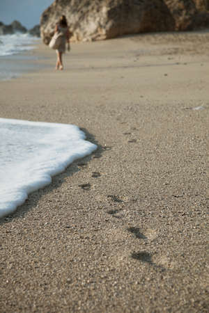 Young woman walking on a beachの写真素材