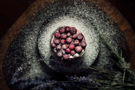 Berry cake with lavender on the wood tableの写真素材