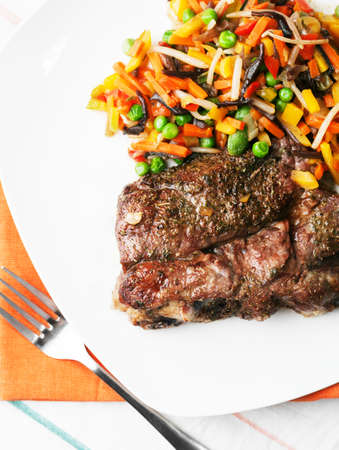 Grilled steak with vegetables salad on the white plate. Healthy nutrition.の写真素材