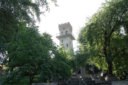 The old tower surrounded by green trees.の写真素材