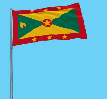 Isolate large cloth of Grenada on a flagpole fluttering in the wind on a blue background, 3d renderingの写真素材