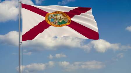 Flag of Florida - US state fluttering in the wind against a cloudy sky 3d renderingの写真素材