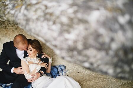 photoshoot lovers in a wedding dress in the mountains near the sの写真素材
