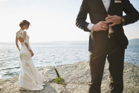 photoshoot lovers in a wedding dress in the mountains near the sの写真素材