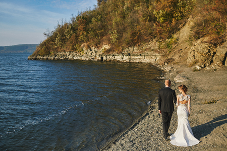 photoshoot lovers in a wedding dress in the mountains near the sの写真素材