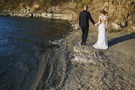 photoshoot lovers in a wedding dress in the mountains near the sの写真素材