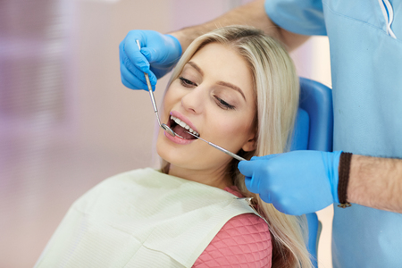 treatment of the patient girl in the dental clinicの写真素材