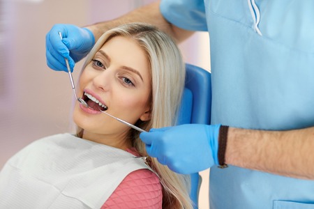 treatment of the patient girl in the dental clinicの写真素材
