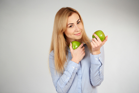 Healthy girl in diferent emotions, with green appleの写真素材