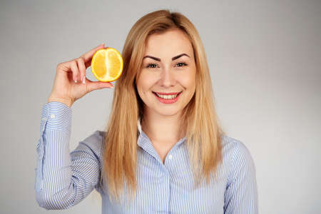 Healthy girl in diferent emotions, with orangeの写真素材
