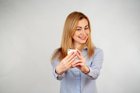 Healthy girl in diferent emotions, with phone doing selfieの写真素材