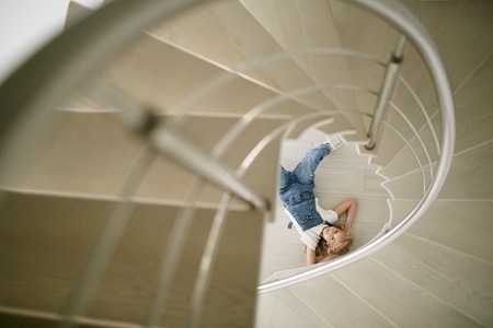 Teen beautiful girl in jeans clothes under the stairs