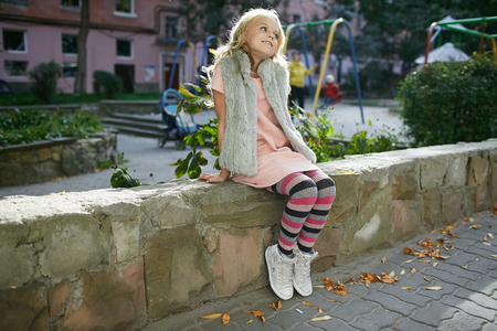 Teen beautiful girl poses outside in the yardの写真素材