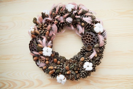 Holiday wreath with cones, cinnamon, berries, acorn on a tree textureの写真素材