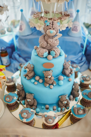 Delicious birthday cake on table on blue backgroundの写真素材