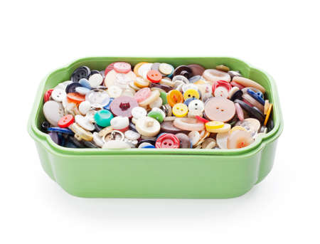 sewing buttons in green plastic casket isolated on white background 