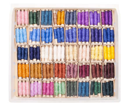 Sewing kit with colored spools of threads isolated on white background の写真素材
