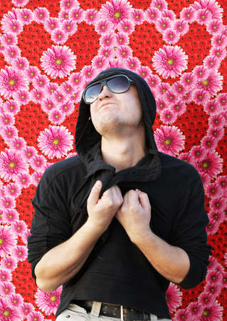 Emotional young man in love on flowers background. Valentineの写真素材