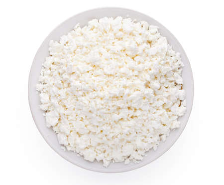 Cottage cheese in plate isolated on white background の写真素材