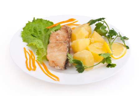 fish and potatoes served isolated on white background の写真素材