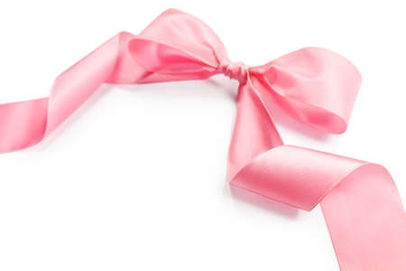 shiny pink satin holiday ribbon and bow isolated on white background with copy spaceの写真素材